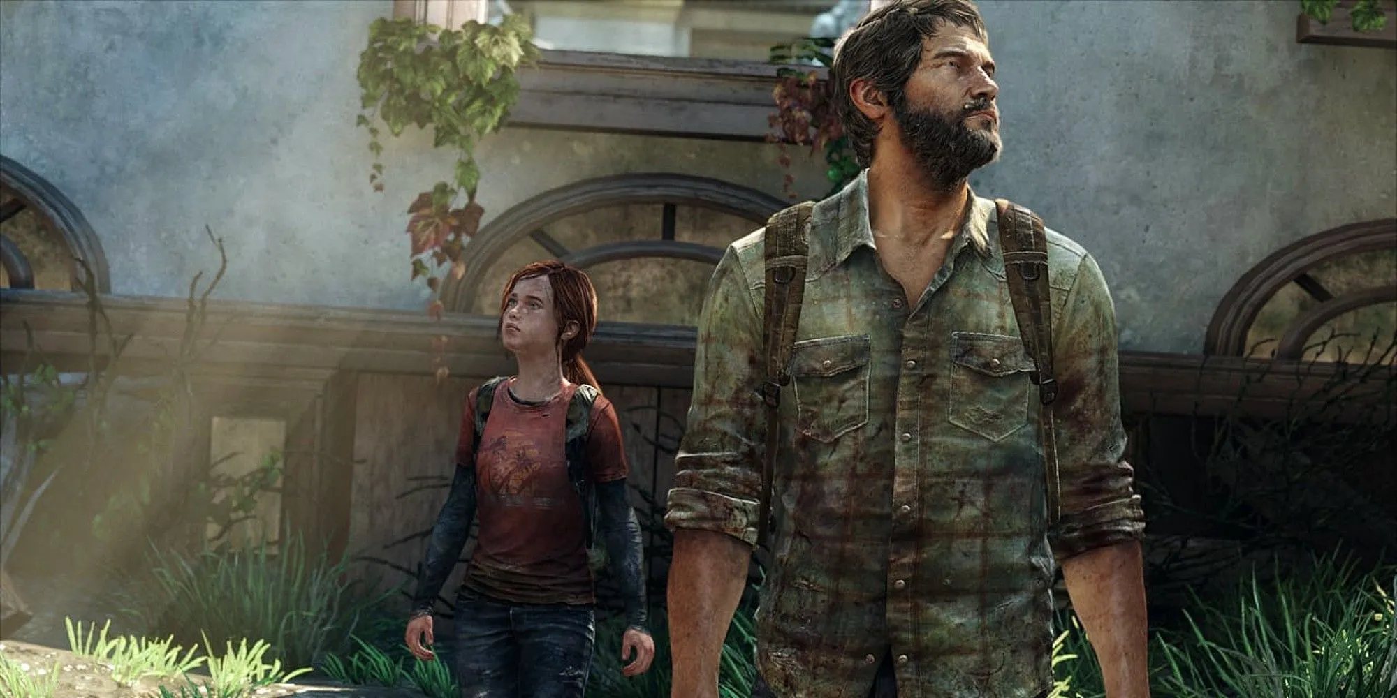 Joel và Ellie, hai nhân vật chính trong game The Last of Us, đứng giữa khung cảnh hoang tàn.