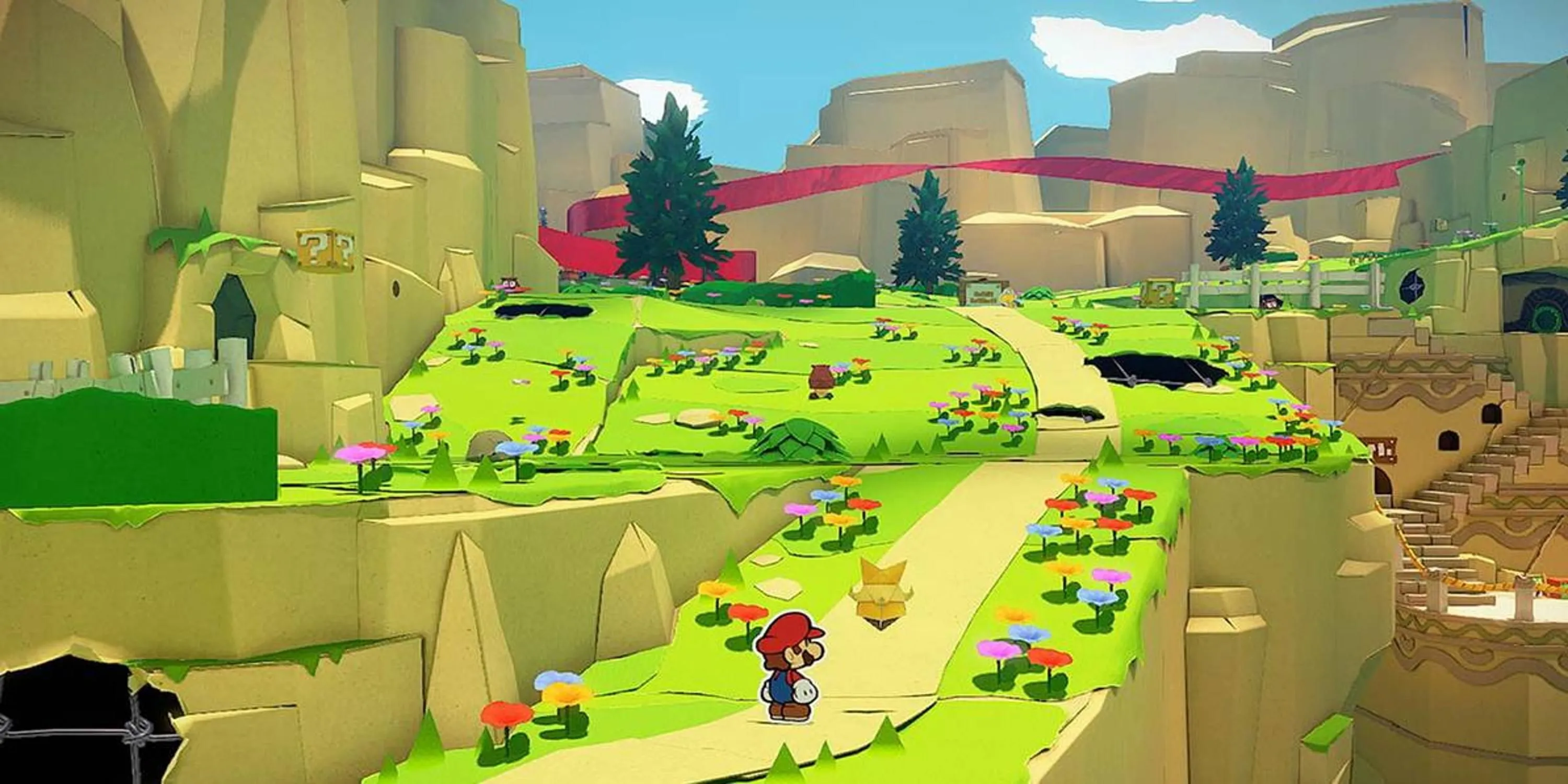 Paper Mario The Origami King - Mario đứng trên con đường dẫn lên đồi, minh họa phong cách đồ họa giấy độc đáo.