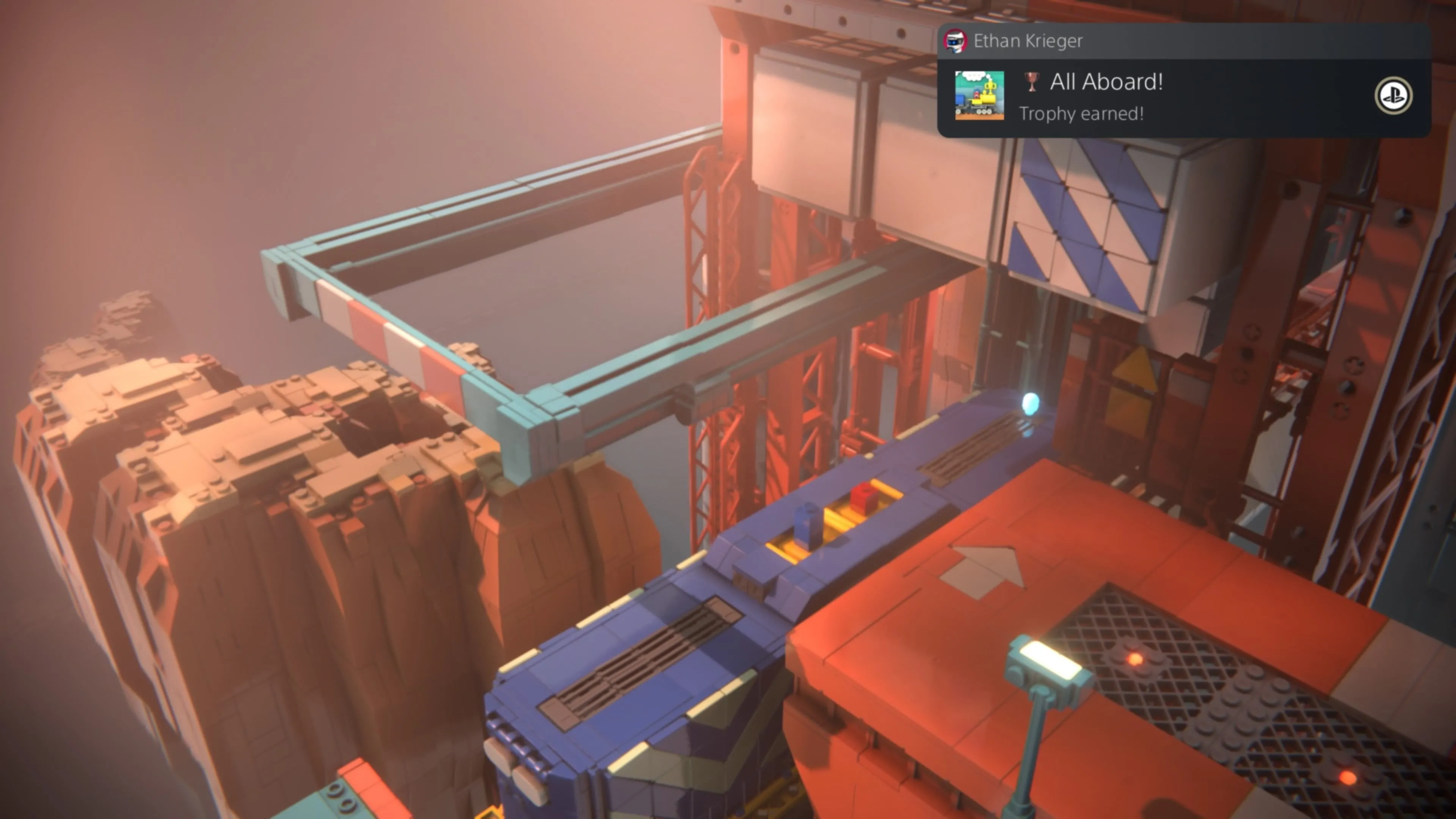 LEGO Voyagers: Hai nhân vật Red và Blue đang gắn vào các điểm kết nối màu vàng trên đầu máy một con tàu tên lửa LEGO, sẵn sàng cho một chuyến đi mới