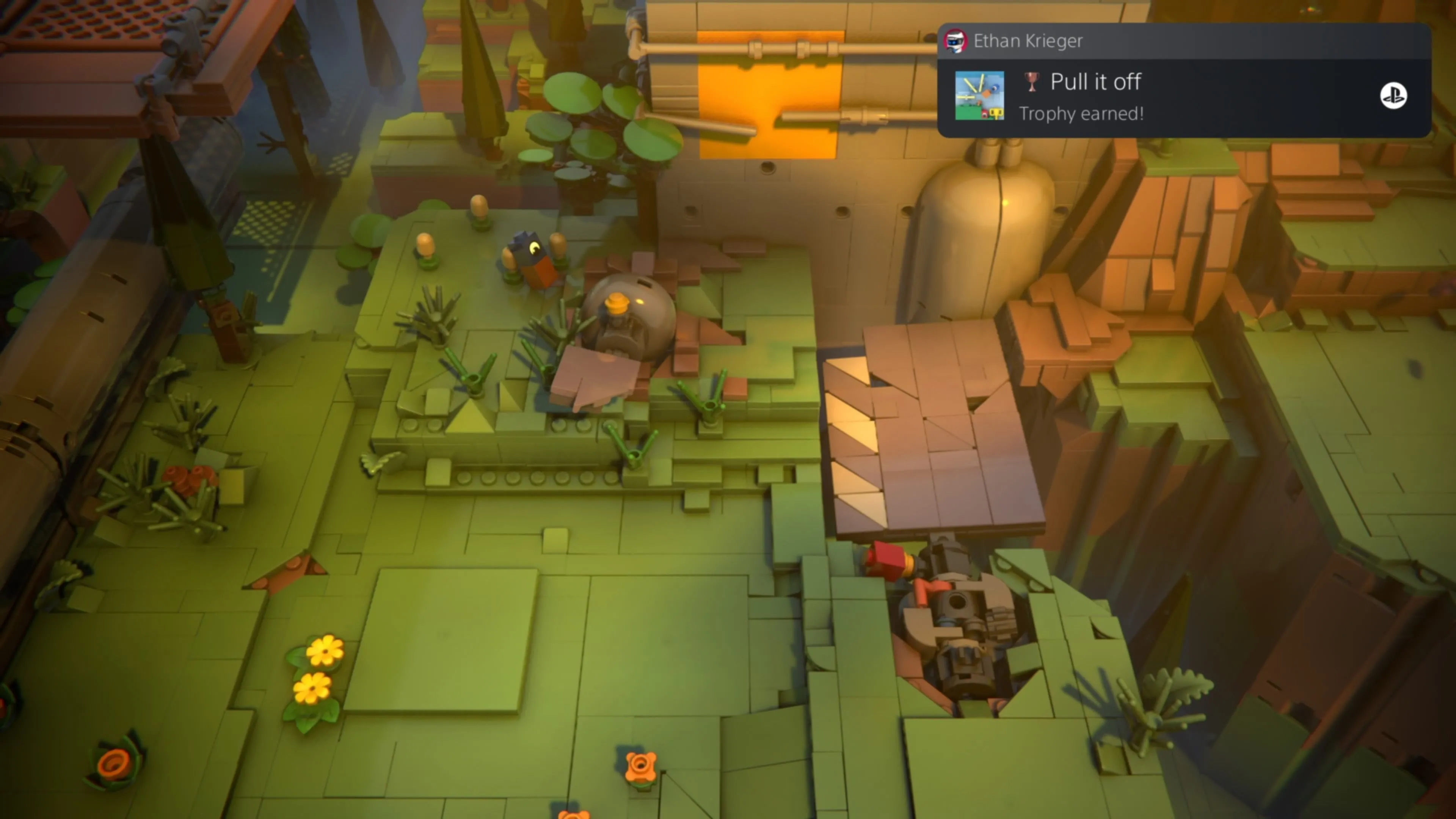 LEGO Voyagers: Hai nhân vật Red và Blue đang hợp sức kéo một viên gạch LEGO màu cam ra khỏi một công tắc, giữ cho một tấm ván đang bị đè xuống