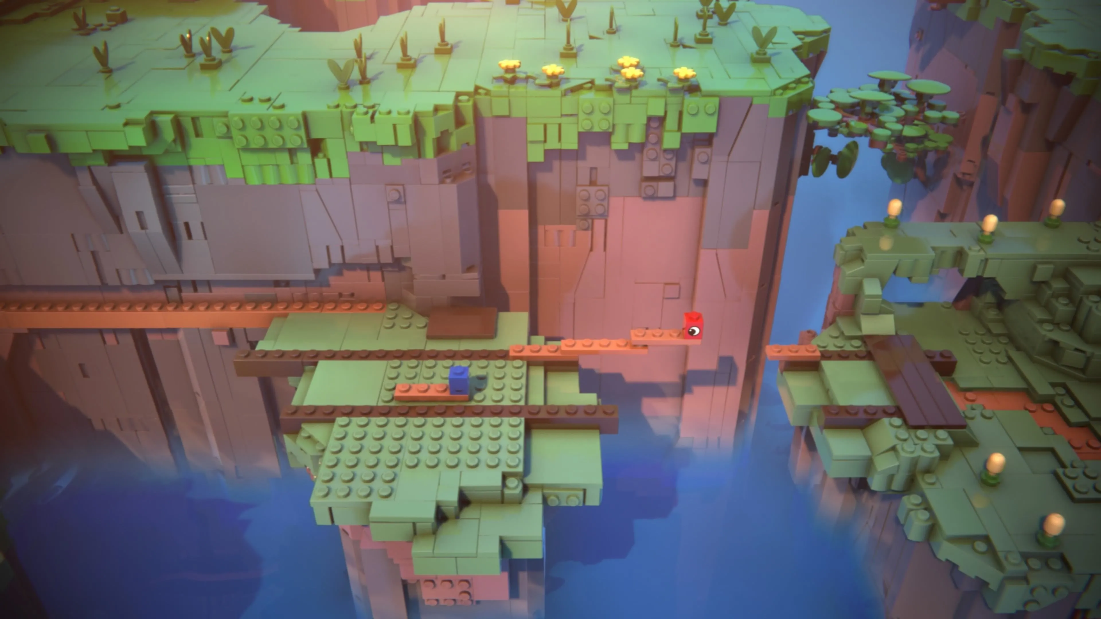 LEGO Voyagers: Hai nhân vật Red và Blue đang lắp ghép các mảnh LEGO màu nâu dài để tạo thành một cây cầu bắc qua khe nứt