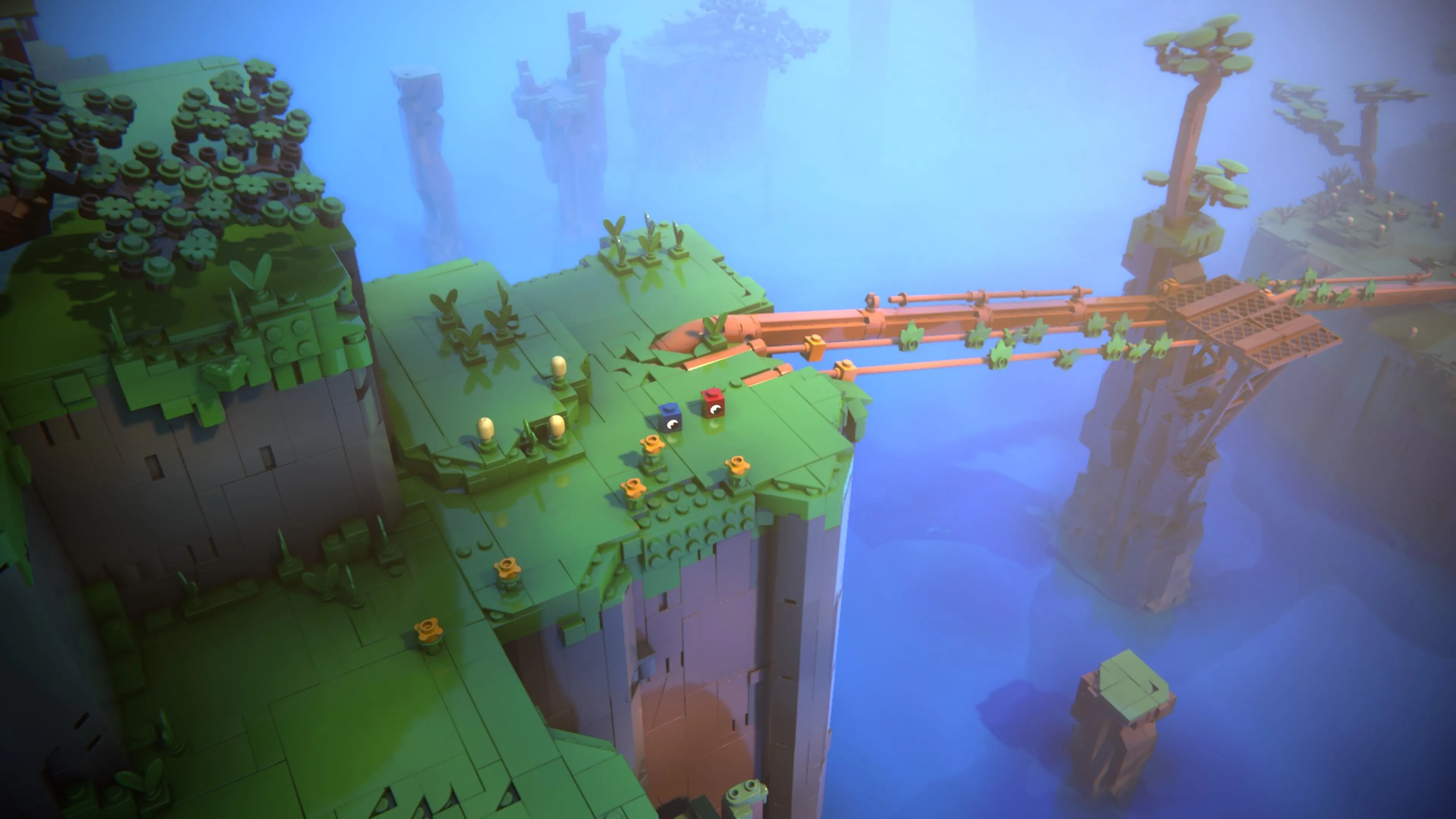 Red và Blue trượt xuống những đường ống khổng lồ bằng gạch vàng trong LEGO Voyagers